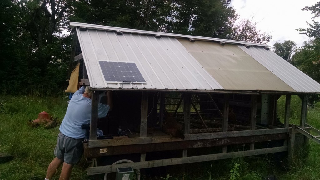 john installing solar on hen wagon