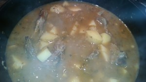 goat loin bones cooking in birria stock